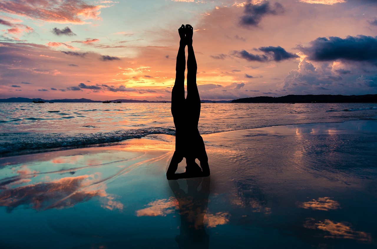 yoga stand in hands silhouette, sunset beach, zen position by the sea-2149407.jpg